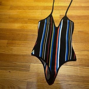 Multi color onesie with deep v and high back.